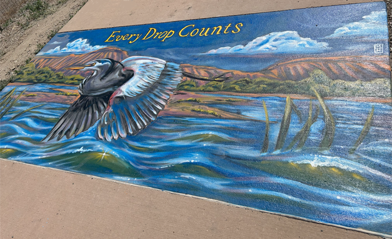 Painting of a blue heron flying over a river with text that says Every Drop Counts.