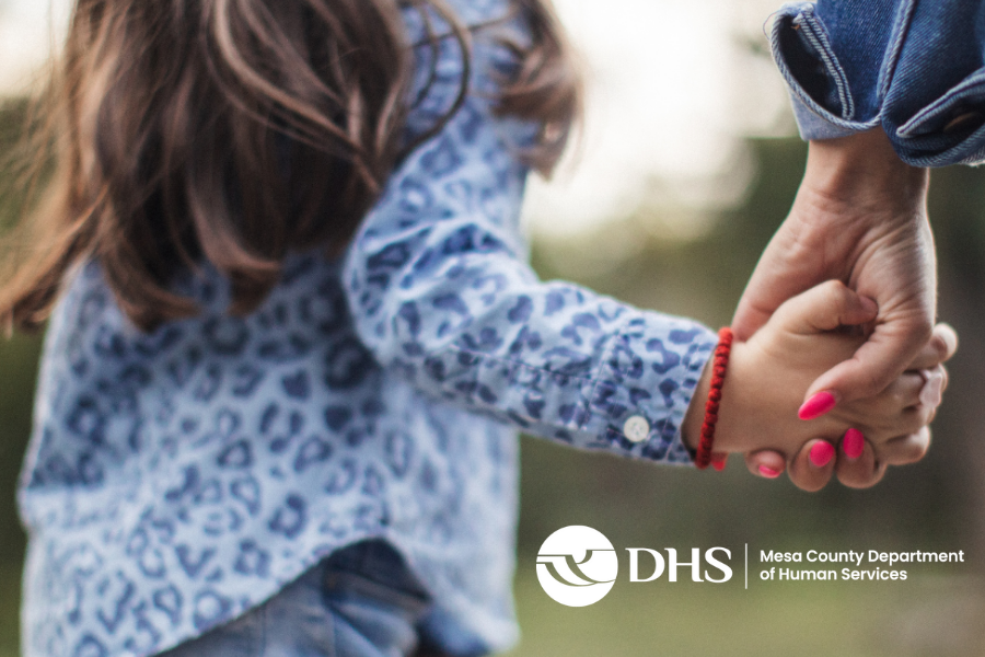 Mom and daughter holding hands with MCDHS logo.