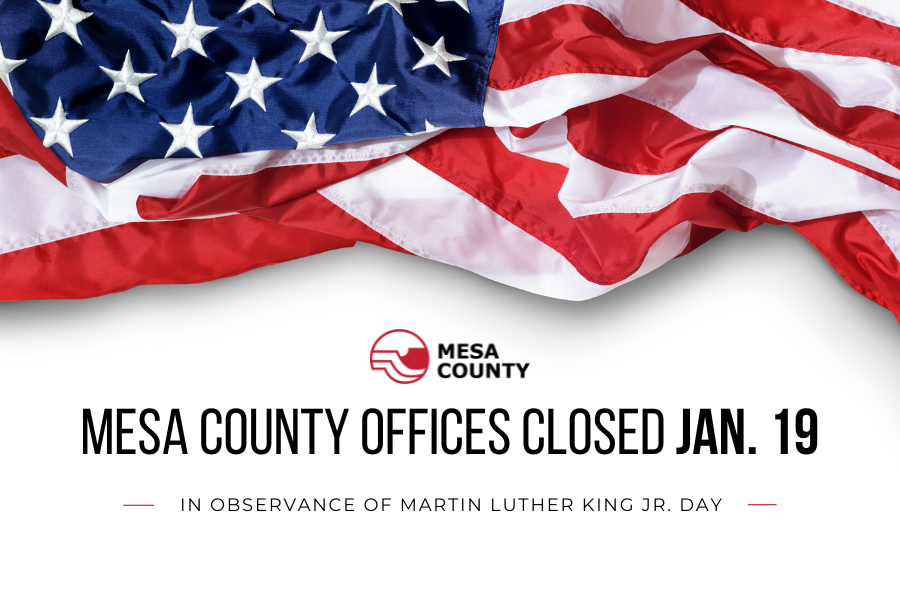 Red and black Mesa County logo and black text reading, "Mesa County Offices Close Jan. 19 in observance of Martin Luther King Jr. Day," below the American flag. 