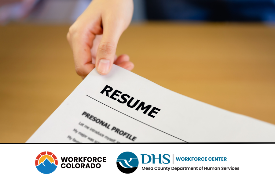 Hand holding a resume with Workforce CO and Mesa County Workforce Center logos