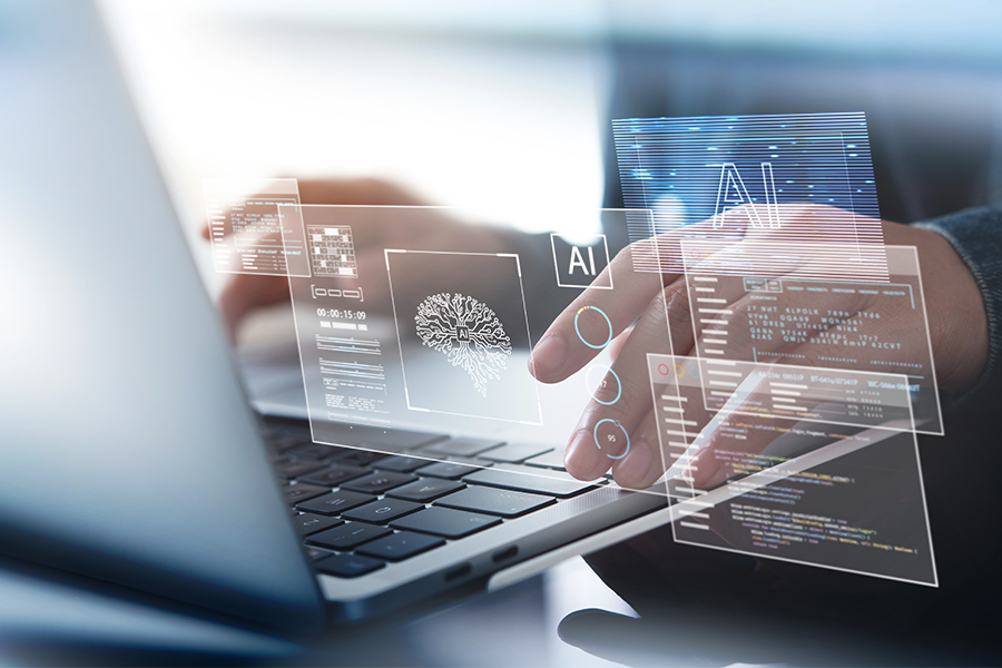 Person using a laptop with digital overlays representing artificial intelligence, data processing and automation tools.
